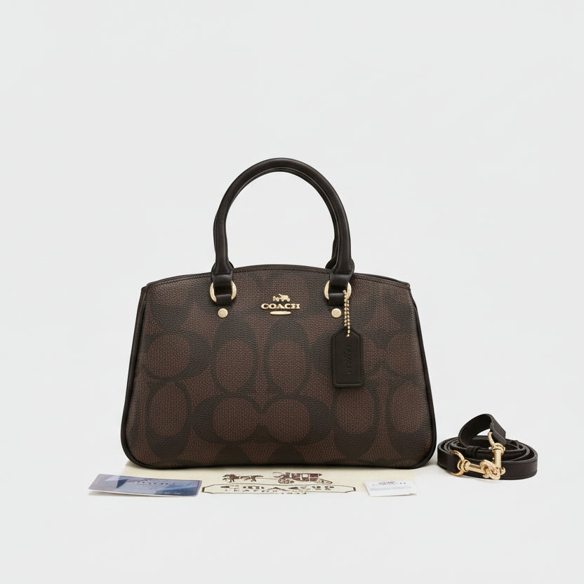Tan Coach Savannah Carryall Bag  Coach handbag with logo on a white surface, featuring the Coach New York brand.