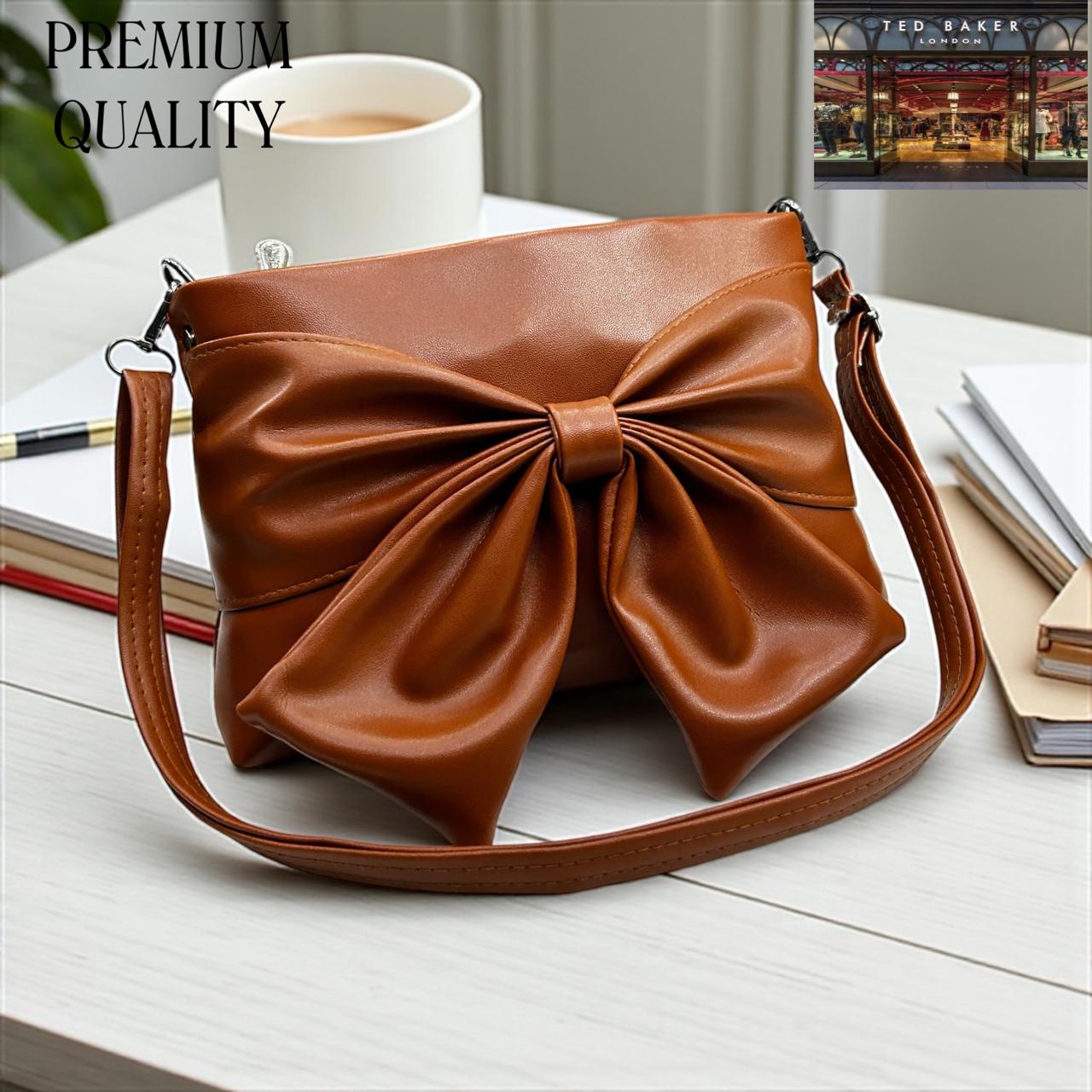 Brown TED BAKER London Premium Sling Bag leather handbag with bow design on a white surface, with 'PREMIUM QUALITY' text above.