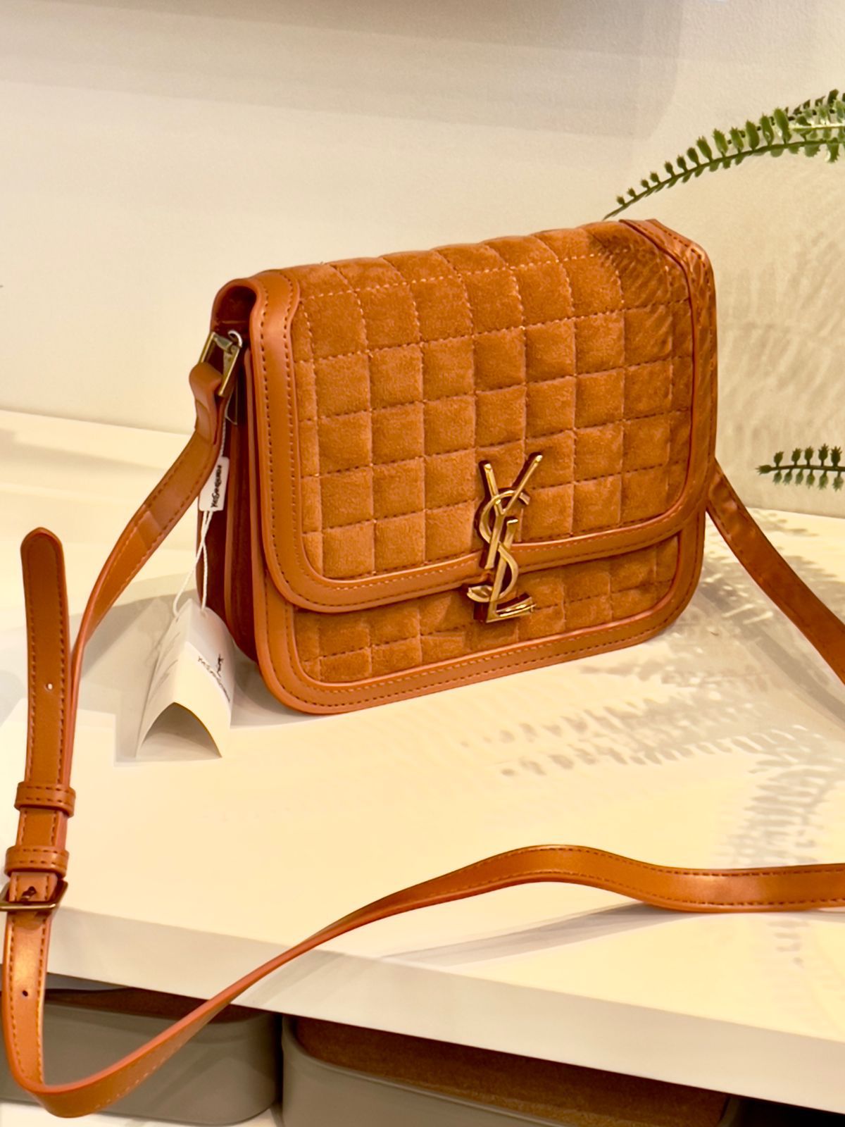 Brown Yves Saint Laurent YSL Premium Shoulder Bag Quilted brown handbag with a brand logo on a light surface.