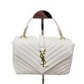 White YSL Saint Laurent Sling Bag quilted handbag with gold accents on a stand against a light gray background