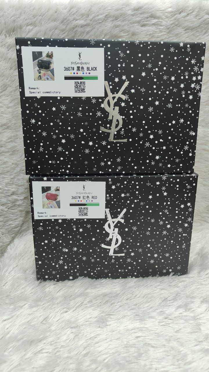YSL boxes with star patterns on a textured surface