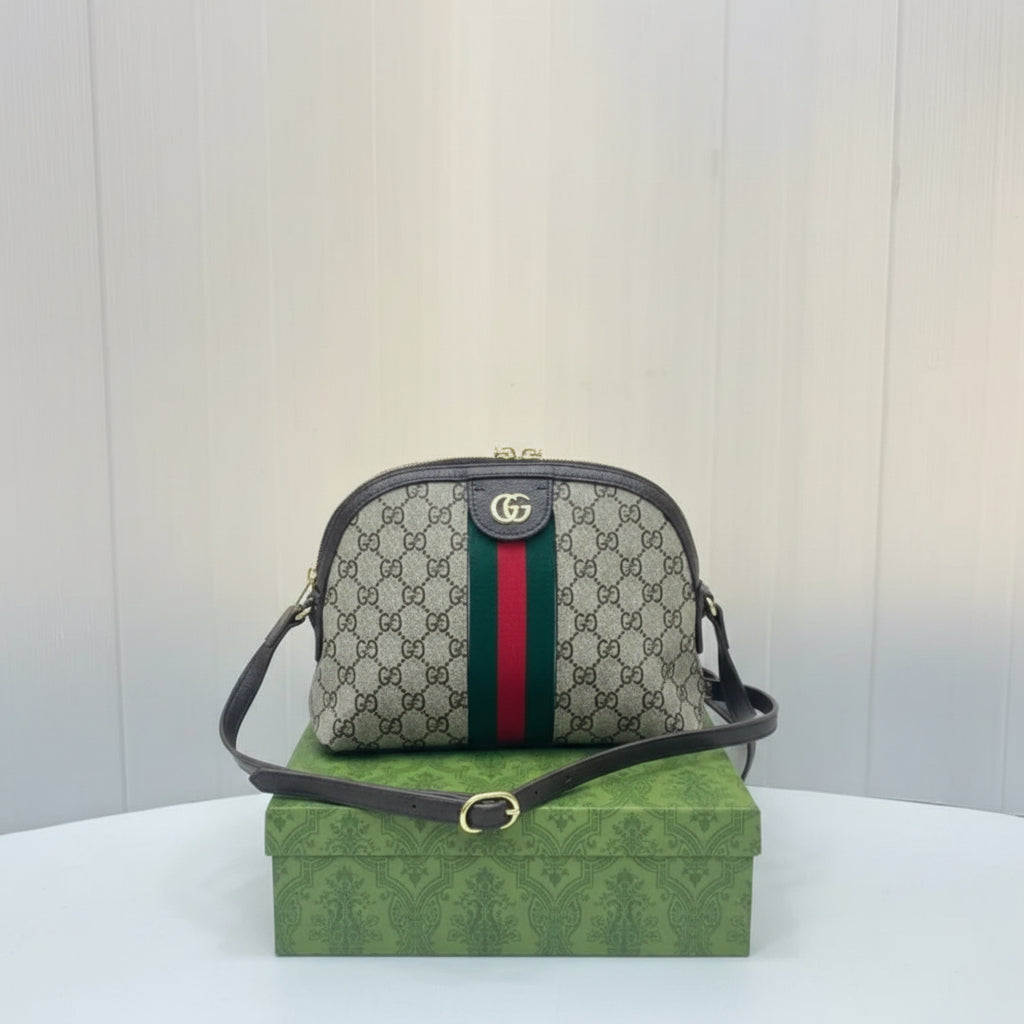 Gucci Ophidia Small Shoulder Bag with green and red stripe on a green box with Gucci logo