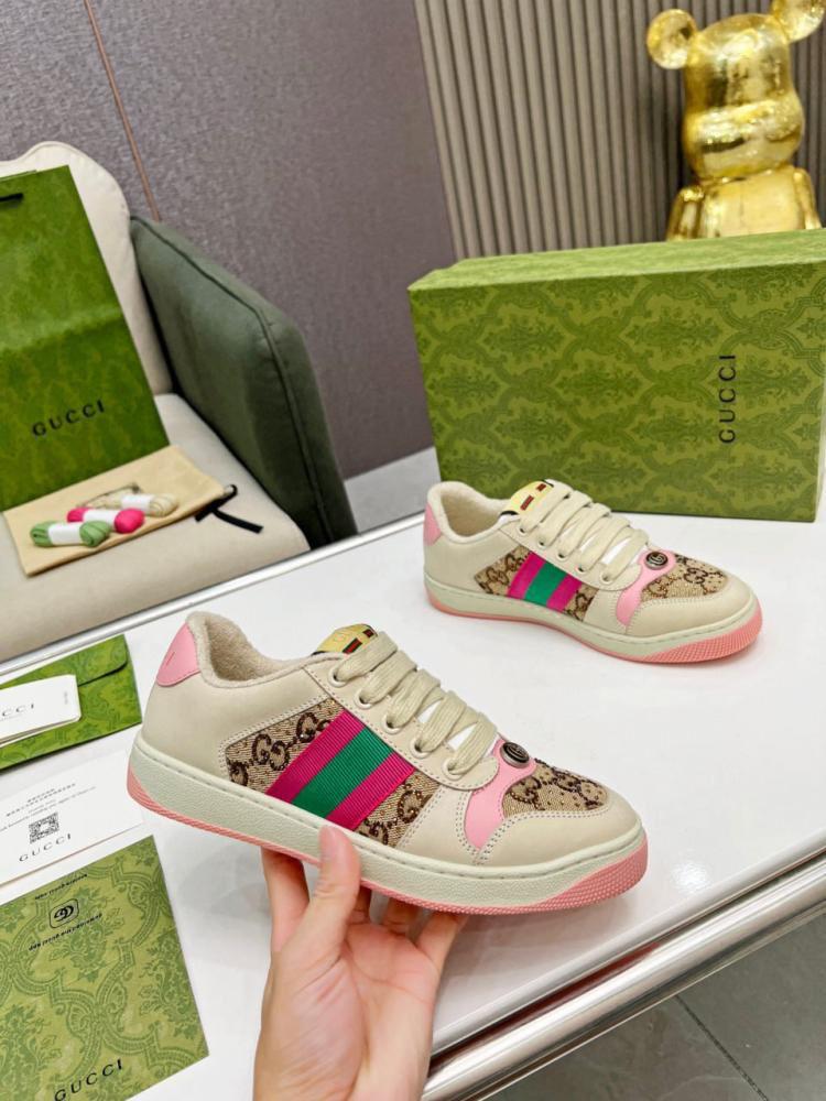 Gucci Women’s Premium Sneakers with colorful stripes on a white surface with Gucci boxes.