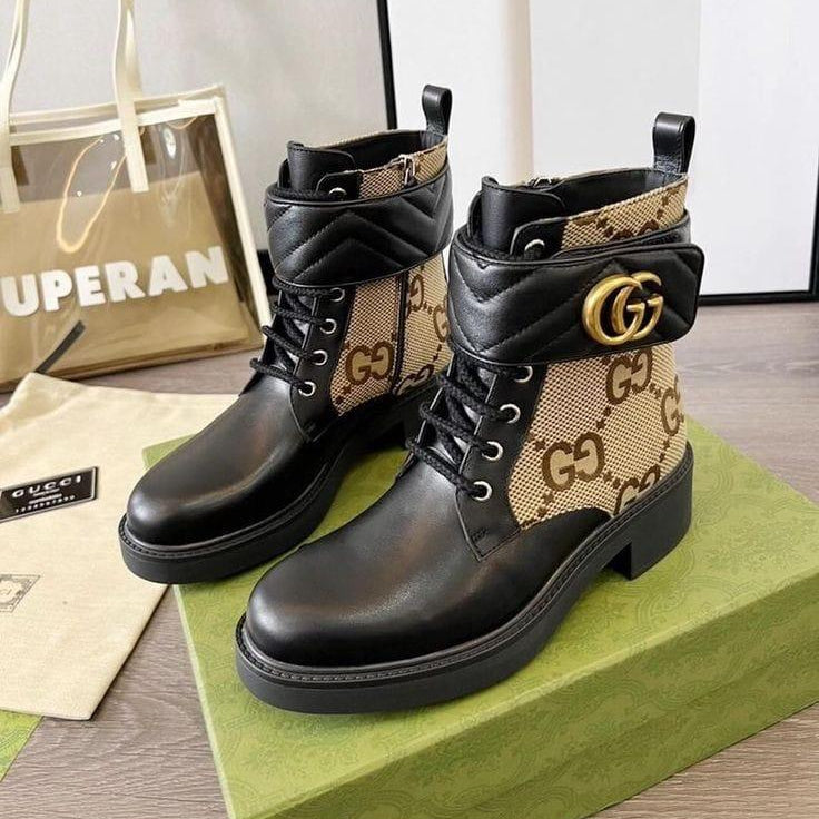 Brown leather boots with Gucci logo on a green box