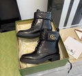 Black Gucci Women’s Premium Leather Boots with Brand Box leather boots with a brand logo in a green box on a reflective surface.