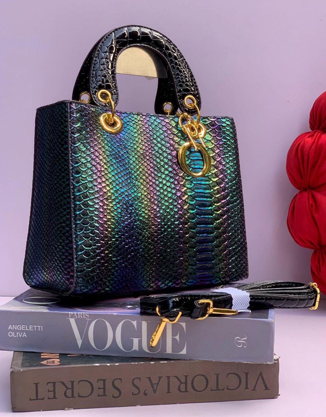 Black Lady Dior Premium Handbag iridescent handbag with gold accents on top of a Vogue magazine