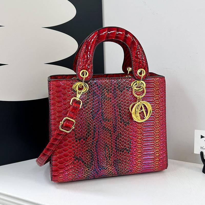 Red Lady Dior Premium Handbag textured handbag with gold hardware on a white surface