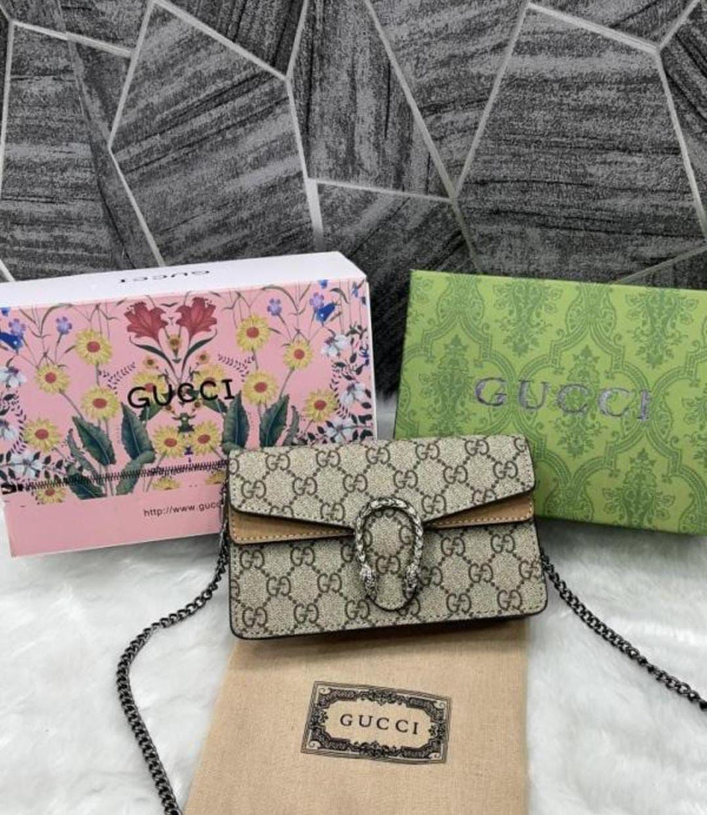 Beige Gucci Dionysus Mini .Gucci handbag with floral and patterned boxes on a textured surface