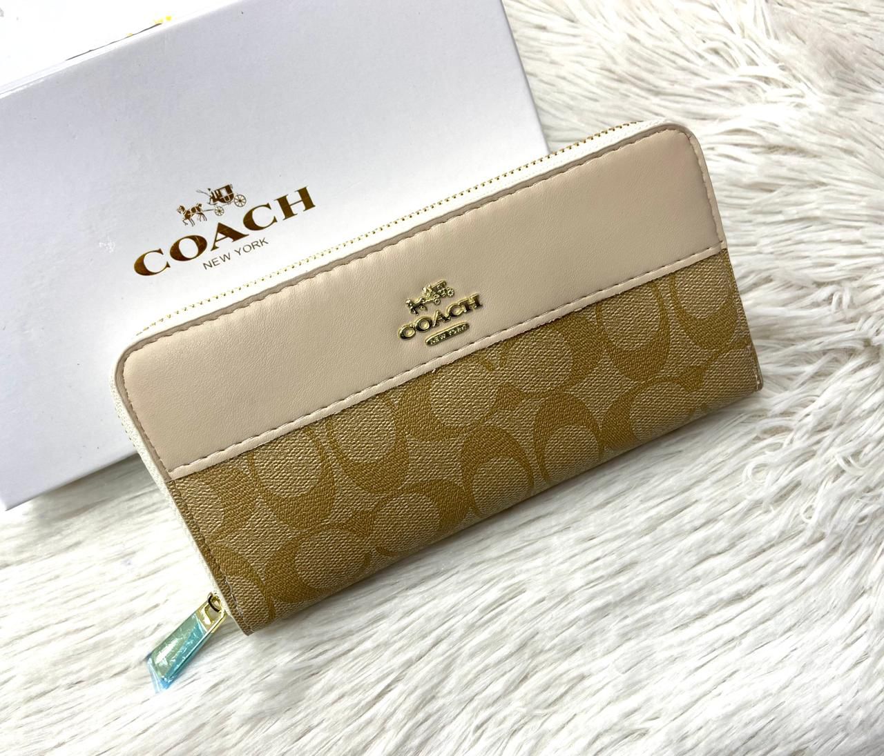 Beige Coach High-Quality Handy Wallet  Coach wallet with logo on a white surface