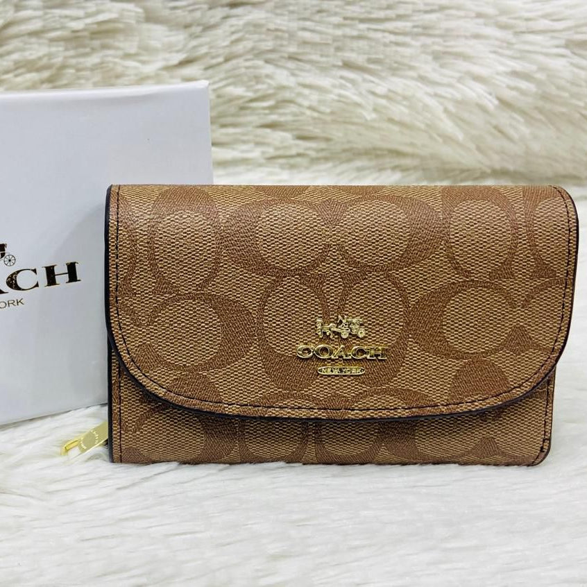 Brown Coach Premium Quality Leather Wallet Coach wallet with logo on a textured surface