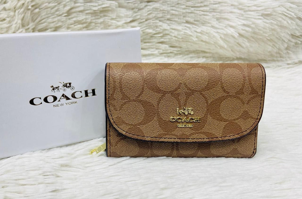 Brown Coach Premium Quality Leather Wallet  Coach wallet with logo on a textured surface