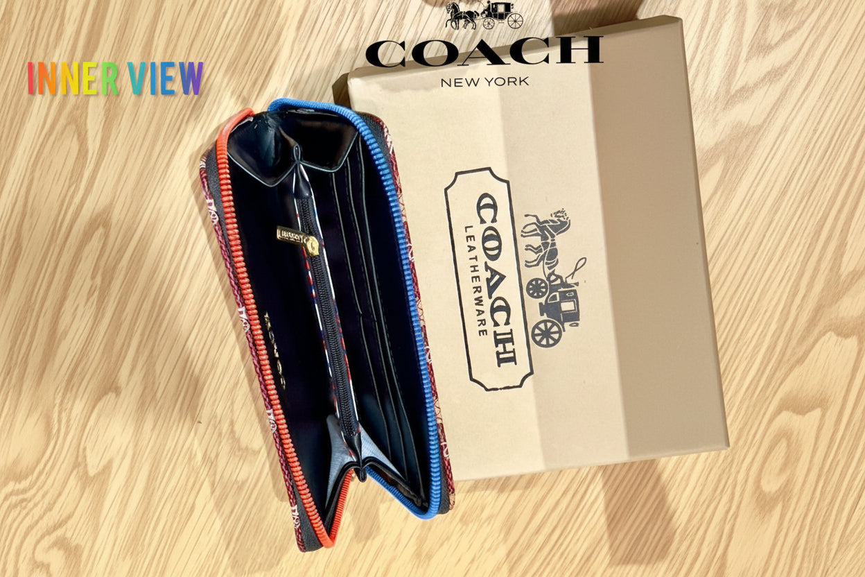 Red Coach Charter Signature Wallets for Women Coach wallet with open zipper on a wooden surface, featuring the Coach logo.
