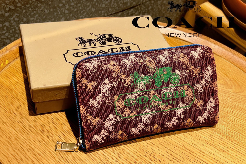 Red Coach Charter Signature Wallets for Women Coach wallet with brand logo on a wooden surface