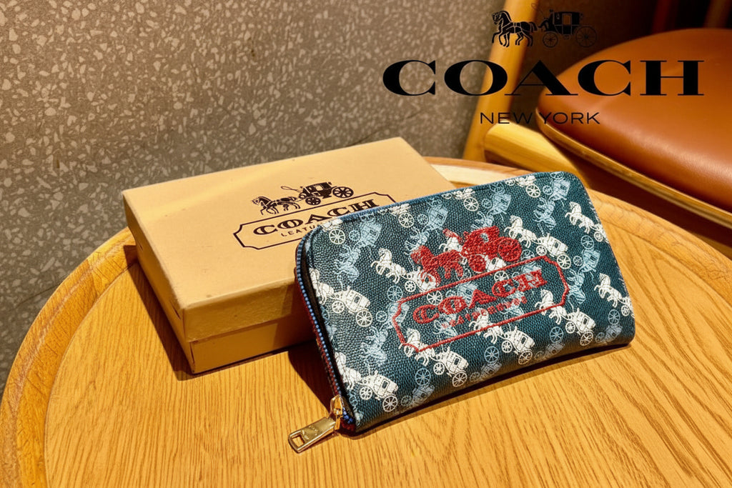 Blue Coach wallet with logo and packaging on a wooden surface