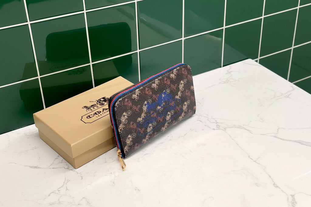 Brown Coach Charter Signature Wallets for Women Coach wallet with floral pattern and gold zipper on a white surface with Coach box in the background.