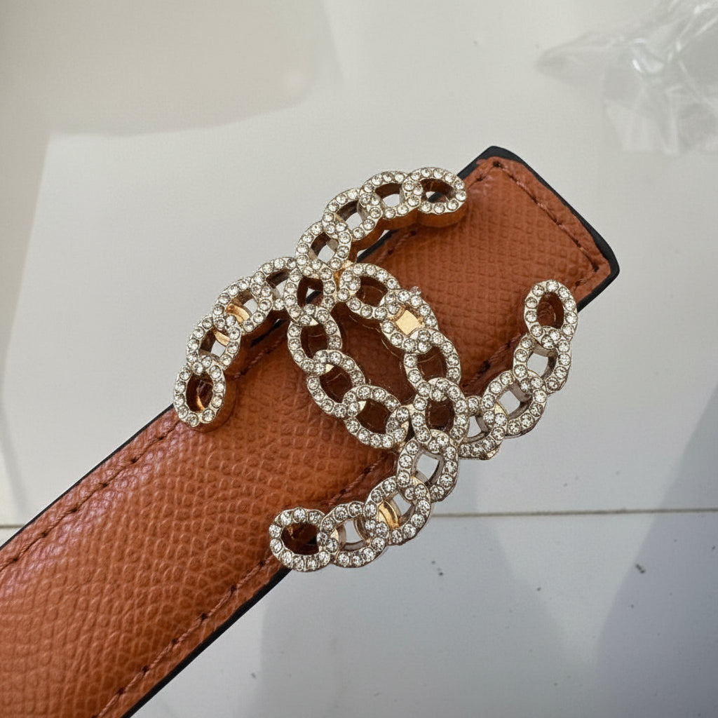 Brown Chanel Studded Reversible Belt Brown leather belt with a decorative chain buckle on a light background