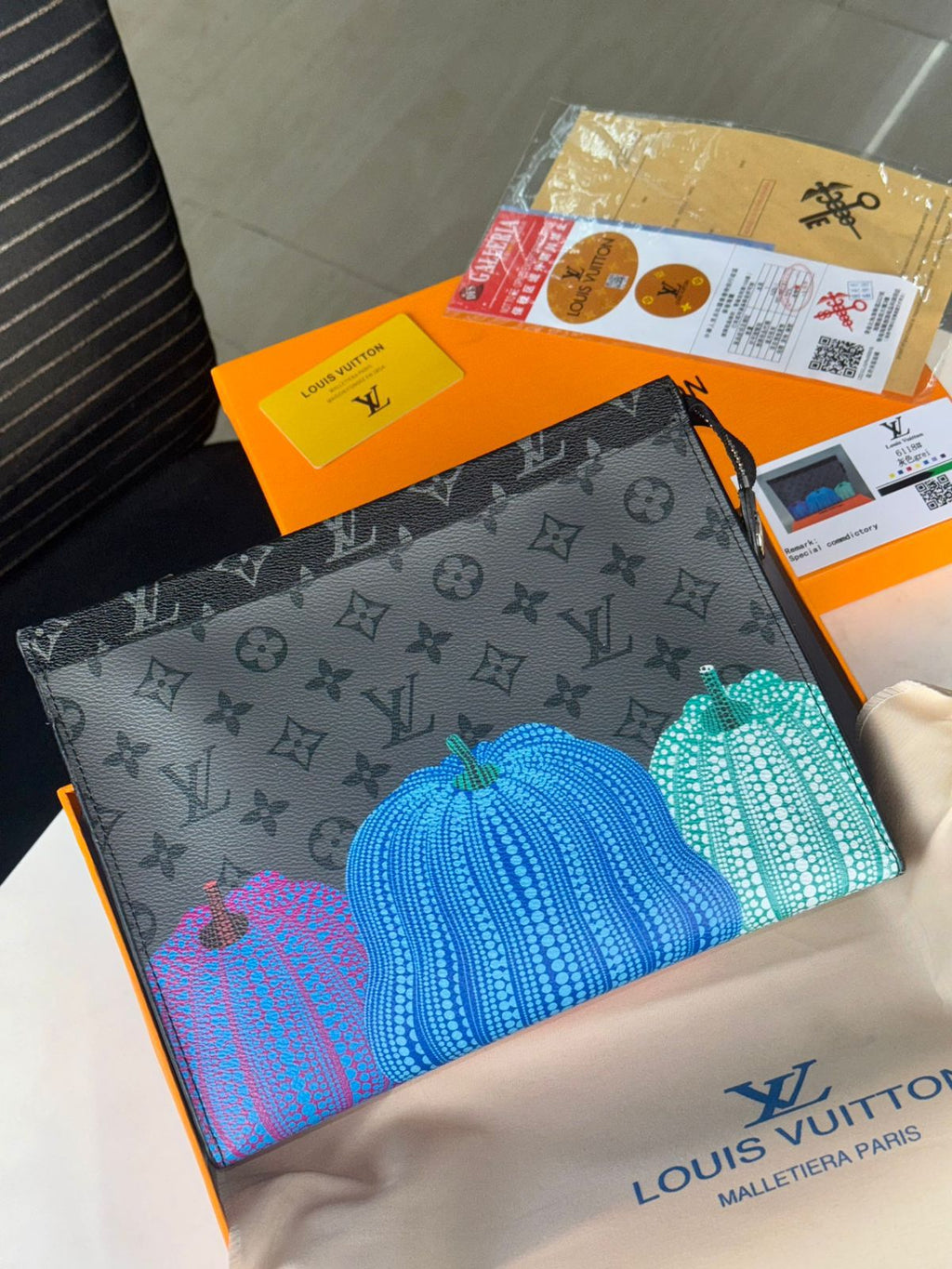 Blue Louis Vuitton Unisex Reverse Pochette Louis Vuitton pouch with pumpkin design on a branded surface