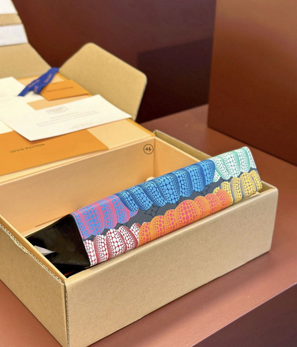 Louis Vuitton Unisex Reverse Pochette Colorful patterned socks in a cardboard box on a wooden surface