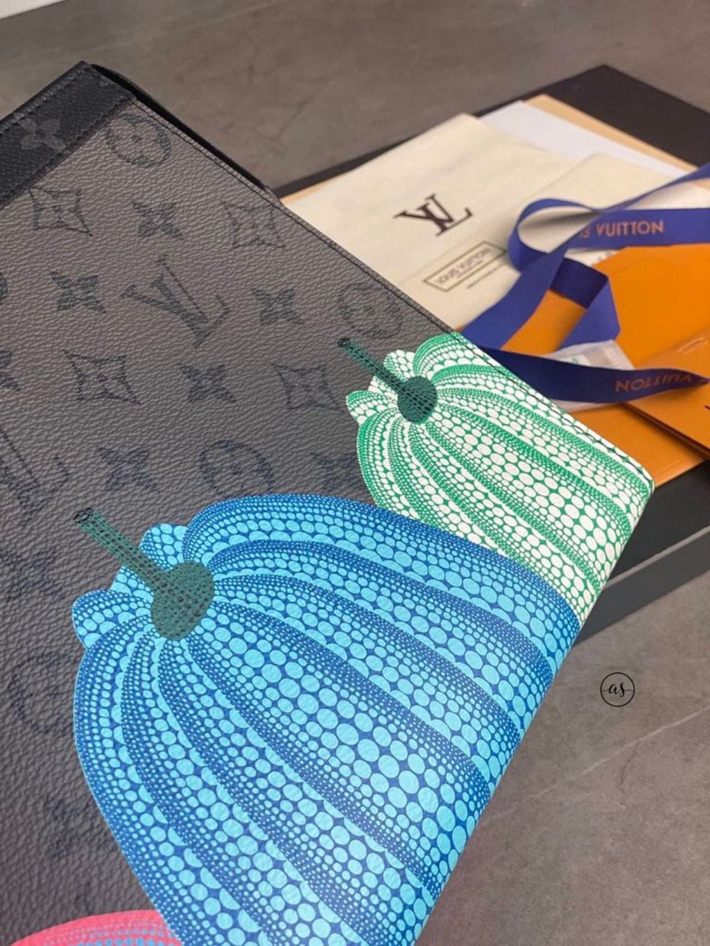 Louis Vuitton Unisex Reverse Pochette Louis Vuitton handbag with pumpkin design on a textured surface