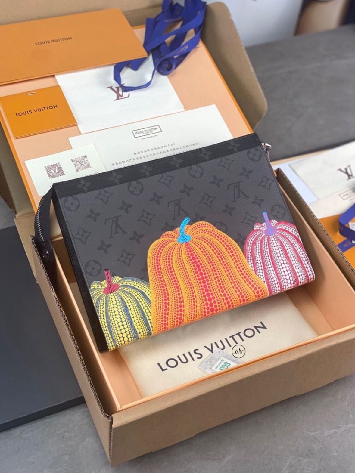 Louis Vuitton Unisex Reverse Pochette Louis Vuitton wallet with colorful pumpkin design in an open box