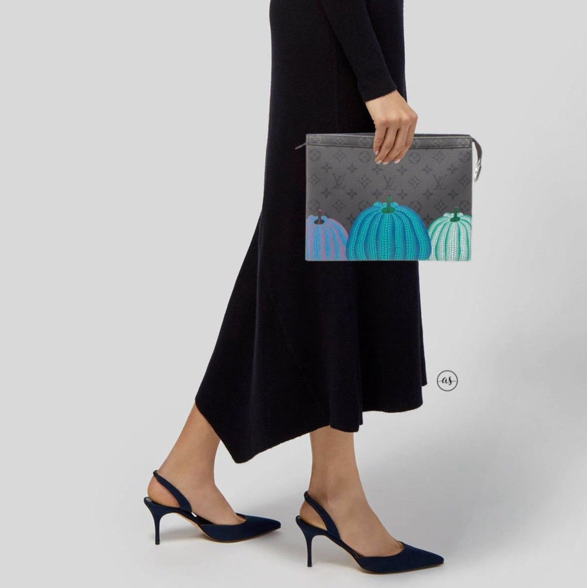 Blue Louis Vuitton Unisex Reverse Pochette Person holding a gray clutch with teal pumpkins on a white background