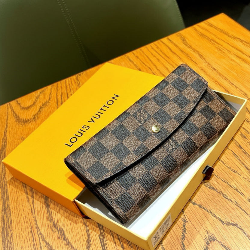 Louis Louis Vuitton Women Wallet in a yellow box on a wooden surface