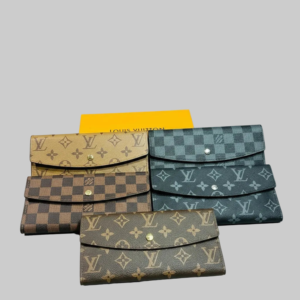 Louis Vuitton wallets with a yellow card displaying the brand name on a wooden surface.