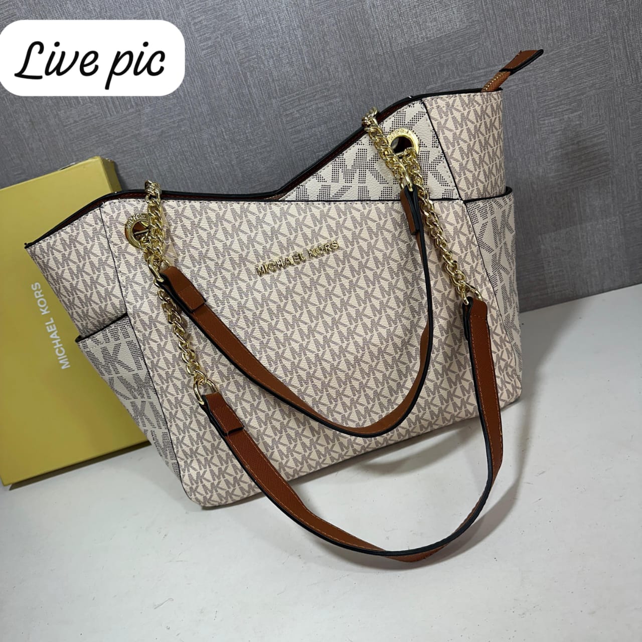 Michael Kors Signature Tote Bag Designer handbag with brown straps and visible brand logo on a gray background