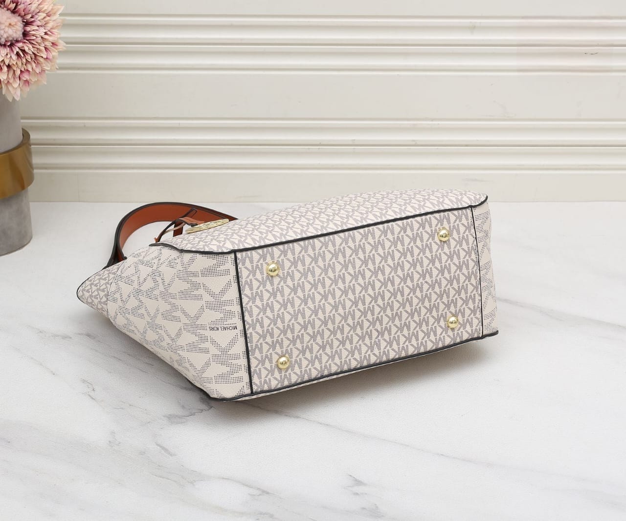 White Michael Kors Signature Tote Bag Designer handbag with brand logo on a marble surface