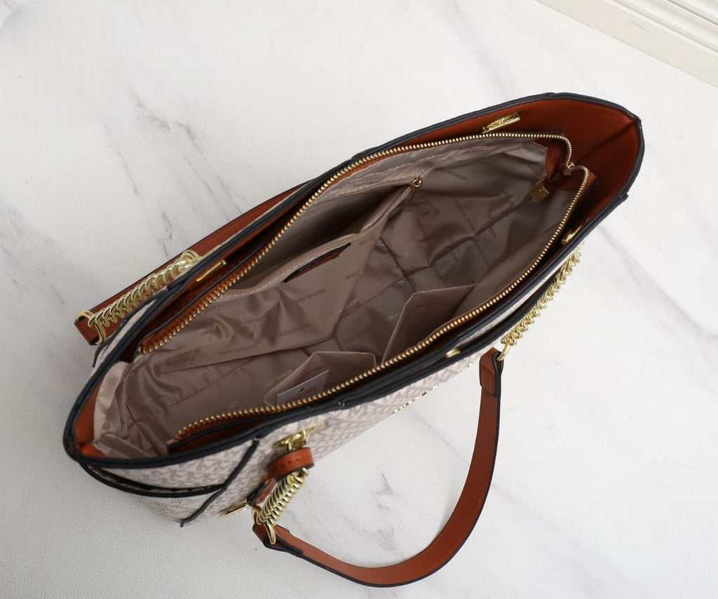 White Michael Kors Signature Tote Bag Open handbag with brown interior on a white marble surface