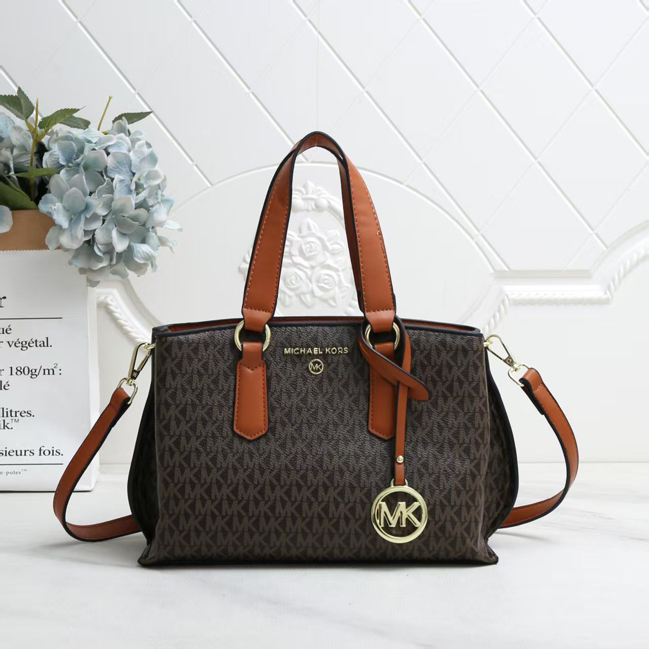 Tan Michael Kors Marilyn Medium Satchel Brown handbag with brown handles and strap on a white background