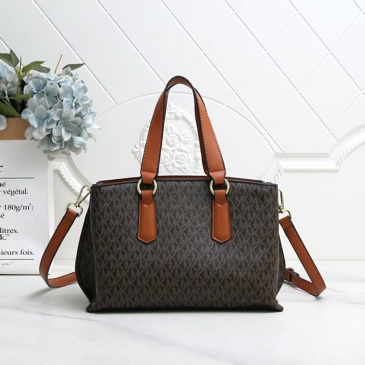 Michael Kors Marilyn Medium Satchel  Brown handbag with tan straps on a white surface