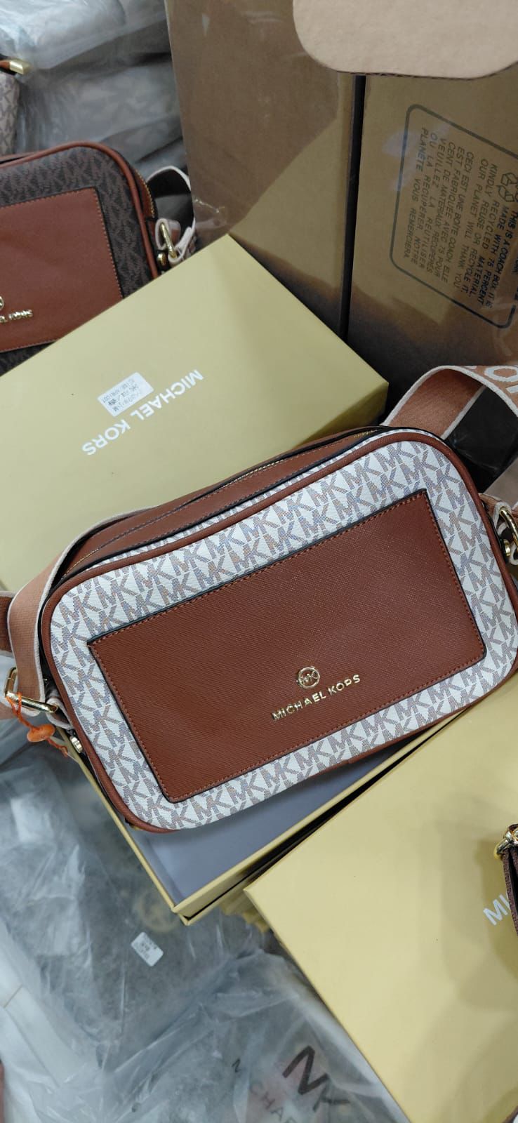 White Michael Kors Kinsley Sling Bag Designer handbag with visible brand logo on a branded box