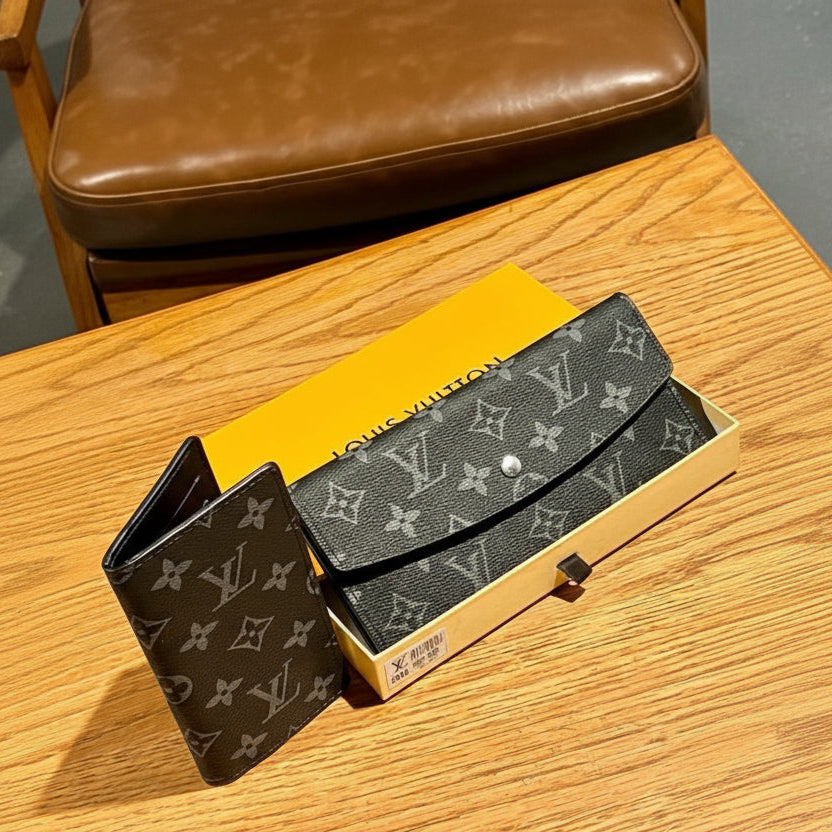 Black Louis Vuitton wallet on a wooden surface with a yellow box