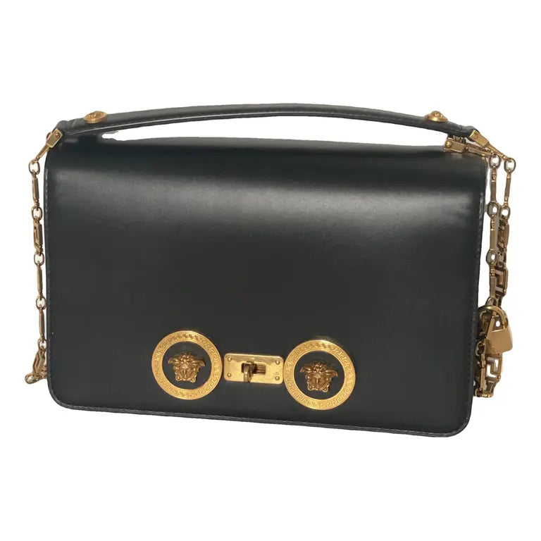 Black medusa handbag with gold chain and Medusa head design on a white background