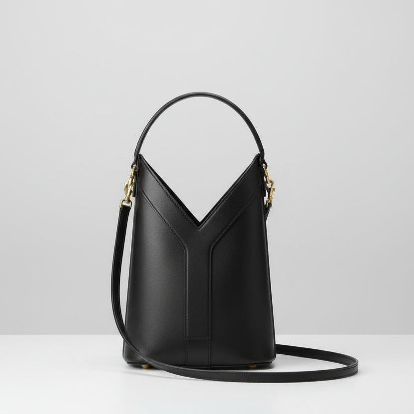 Black YSL Y Top Handle Bucket Bag  handbag with gold accents on a white surface