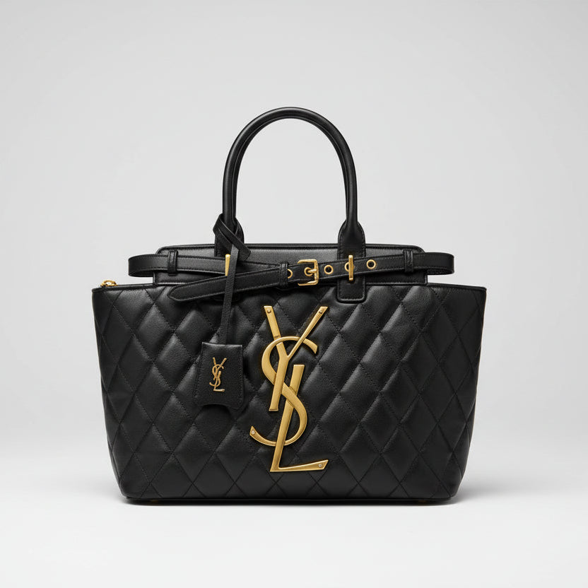 Black YSL Saint Laurent Medium Tote Bag quilted handbag with gold logo on a reflective surface